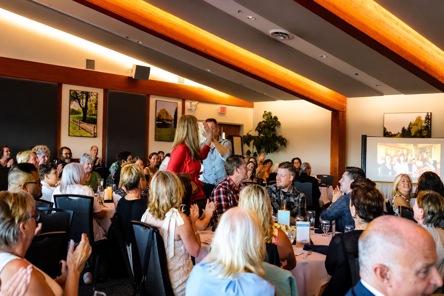 Excellence Seminars International graduates celebrating with a high-five at the banquet