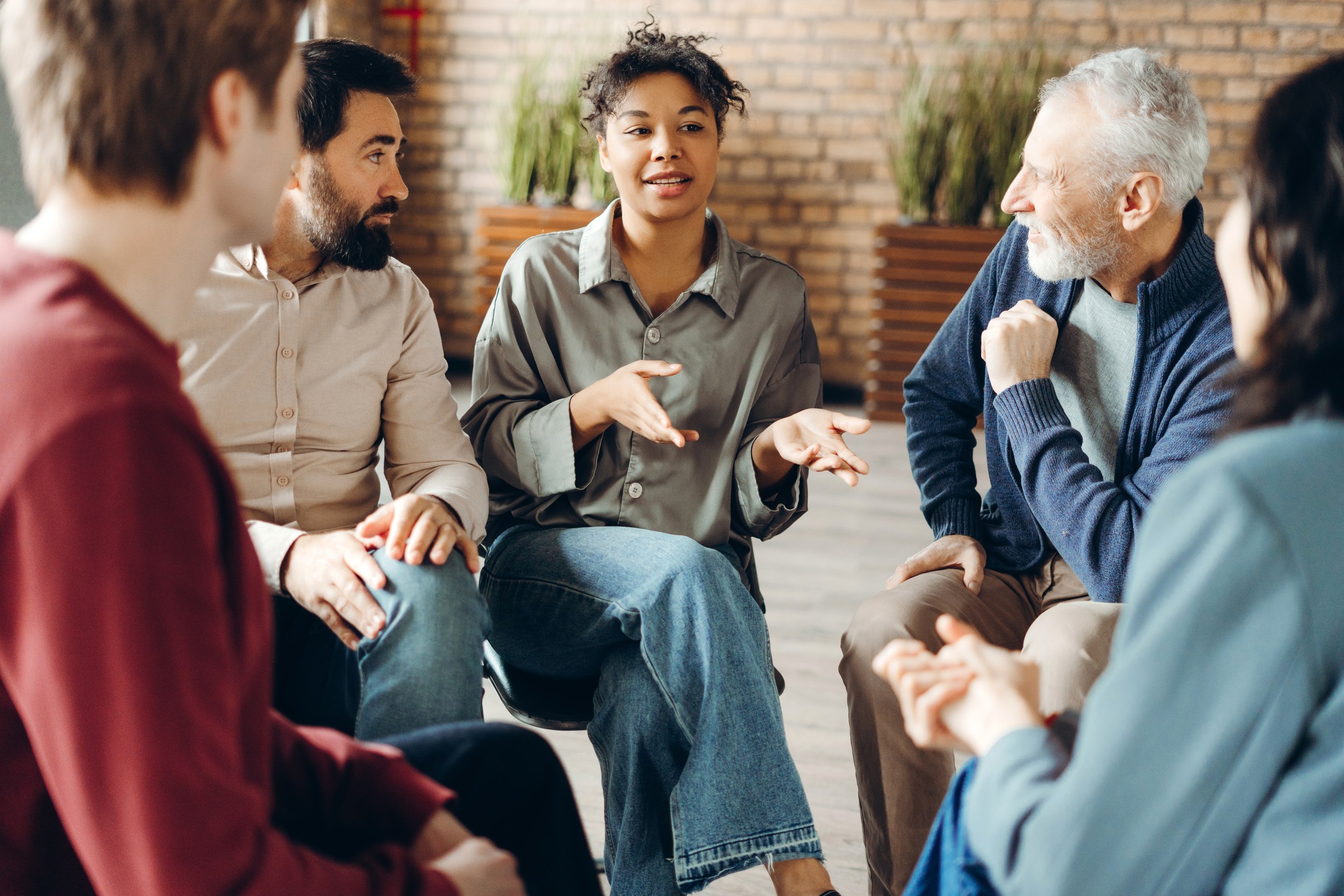 A diverse group of Excellence Seminars participants sitting together in a circle during training