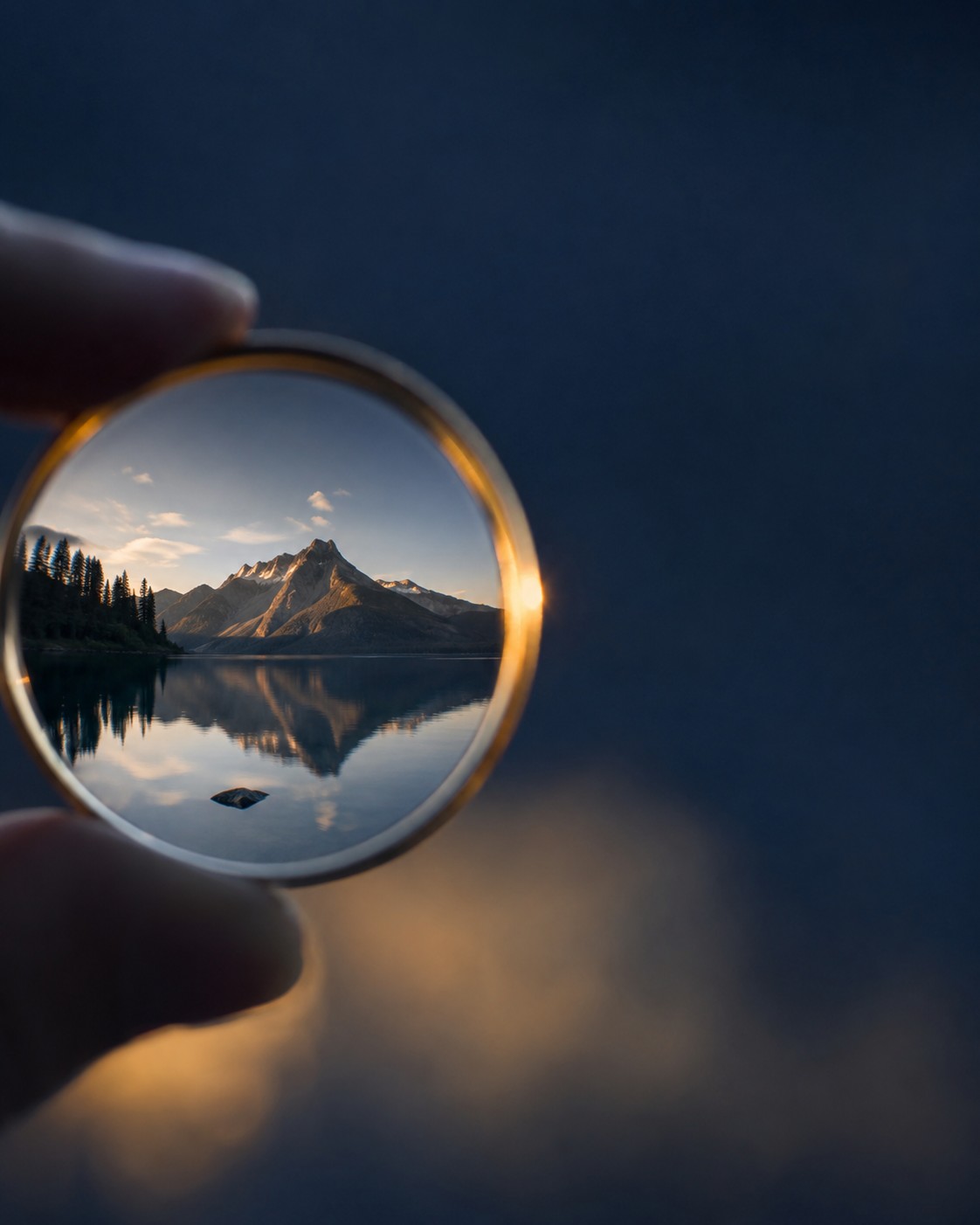 A miniature mountain landscape seen inside a clear glass orb, a metaphor for the personal lens we each see the world through