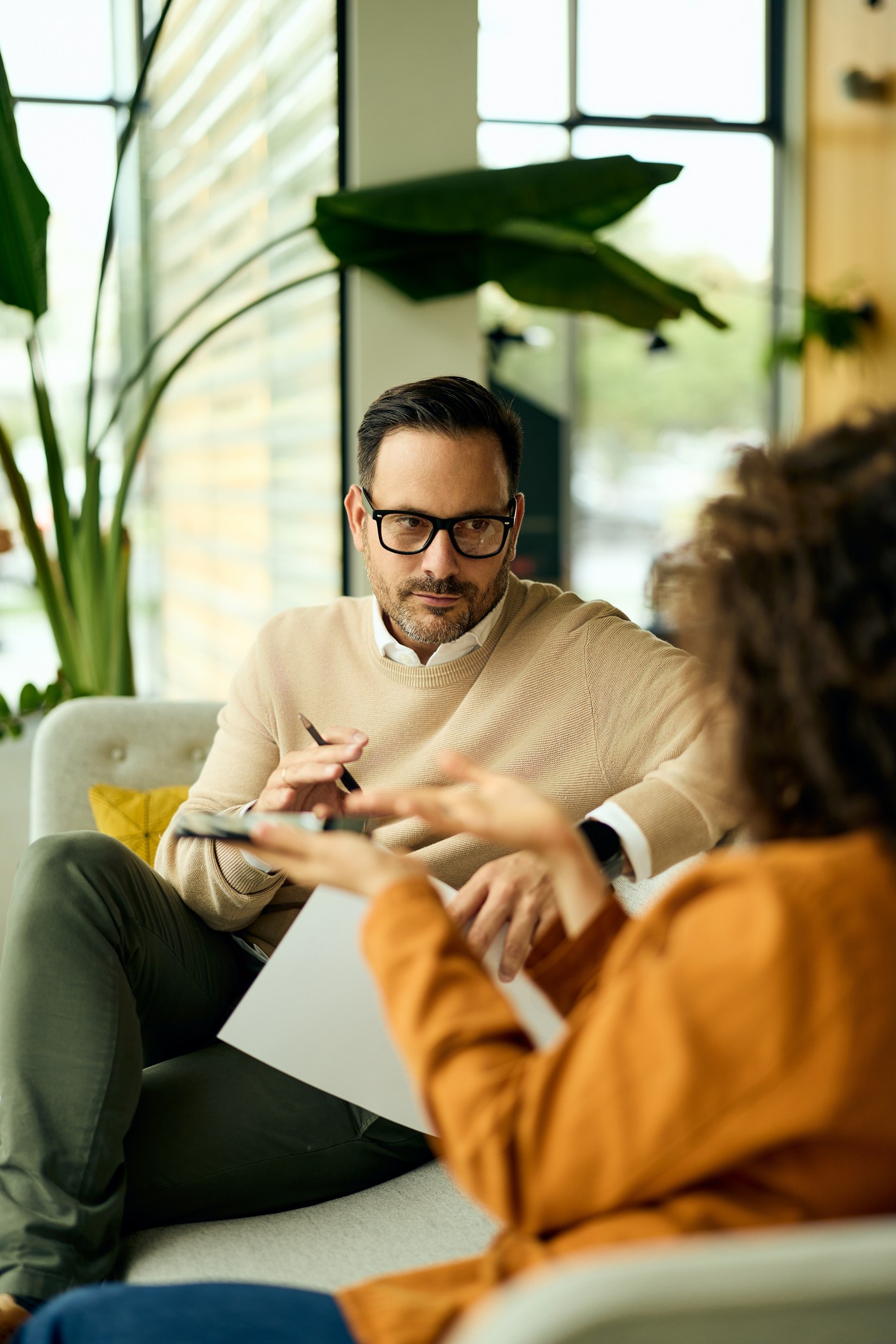 Two colleagues in conversation, showing up openly with each other as they discuss ideas
