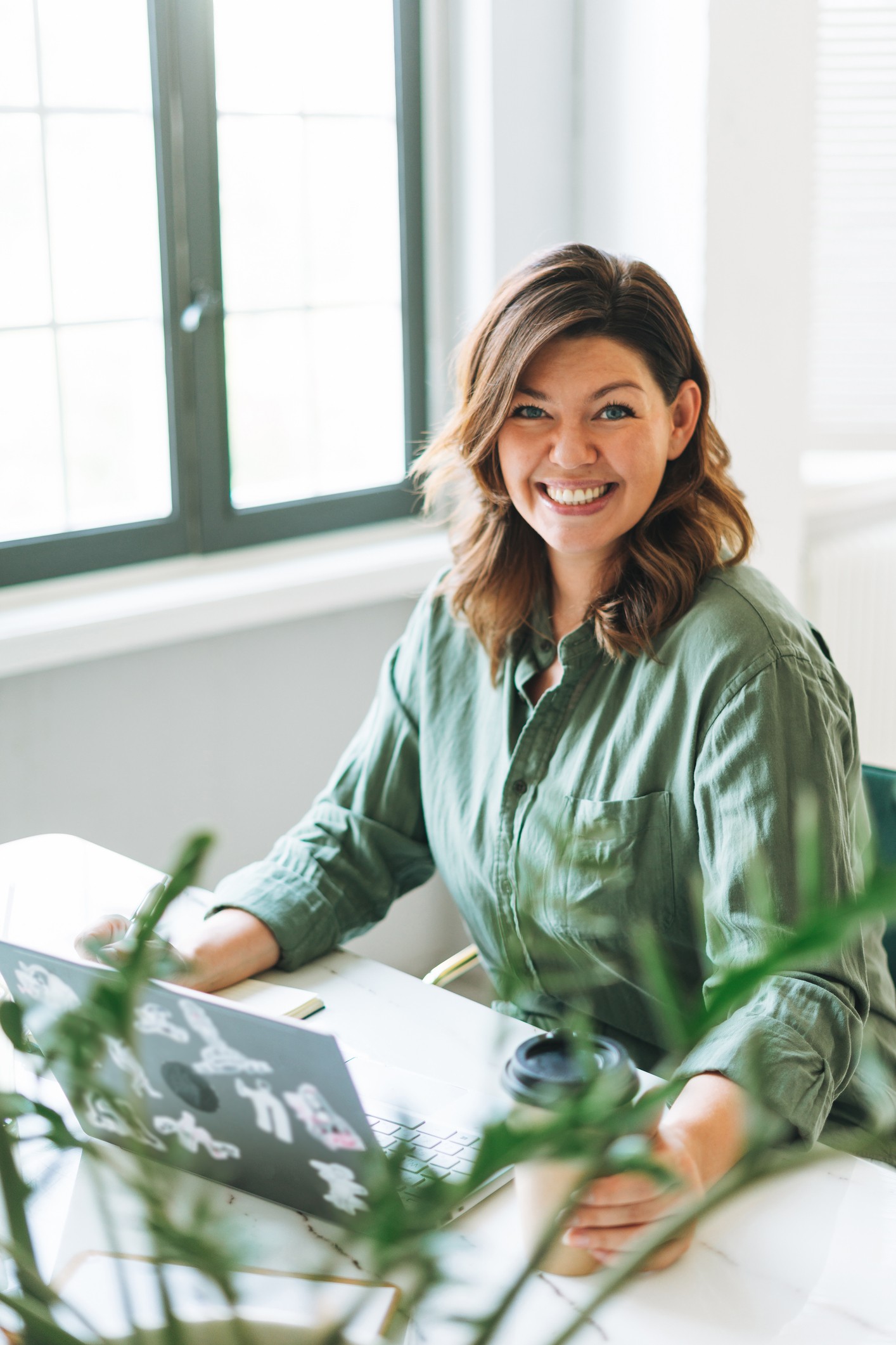 A woman working independently from her laptop, representing the flexible, entrepreneurial nature of the sales role